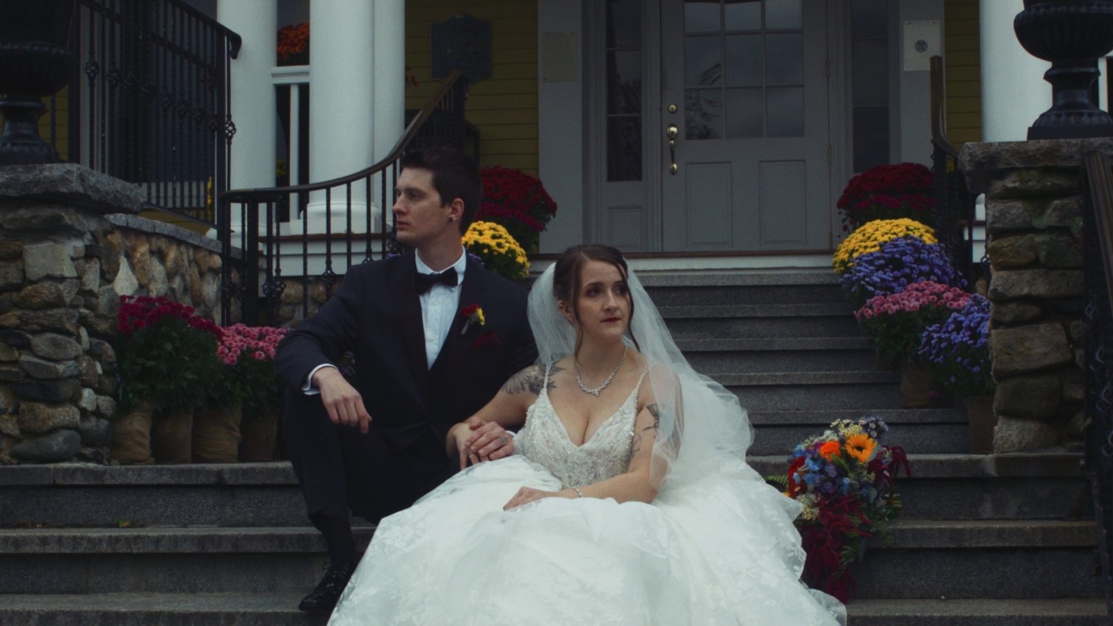 Couple on steps with autumn flowers